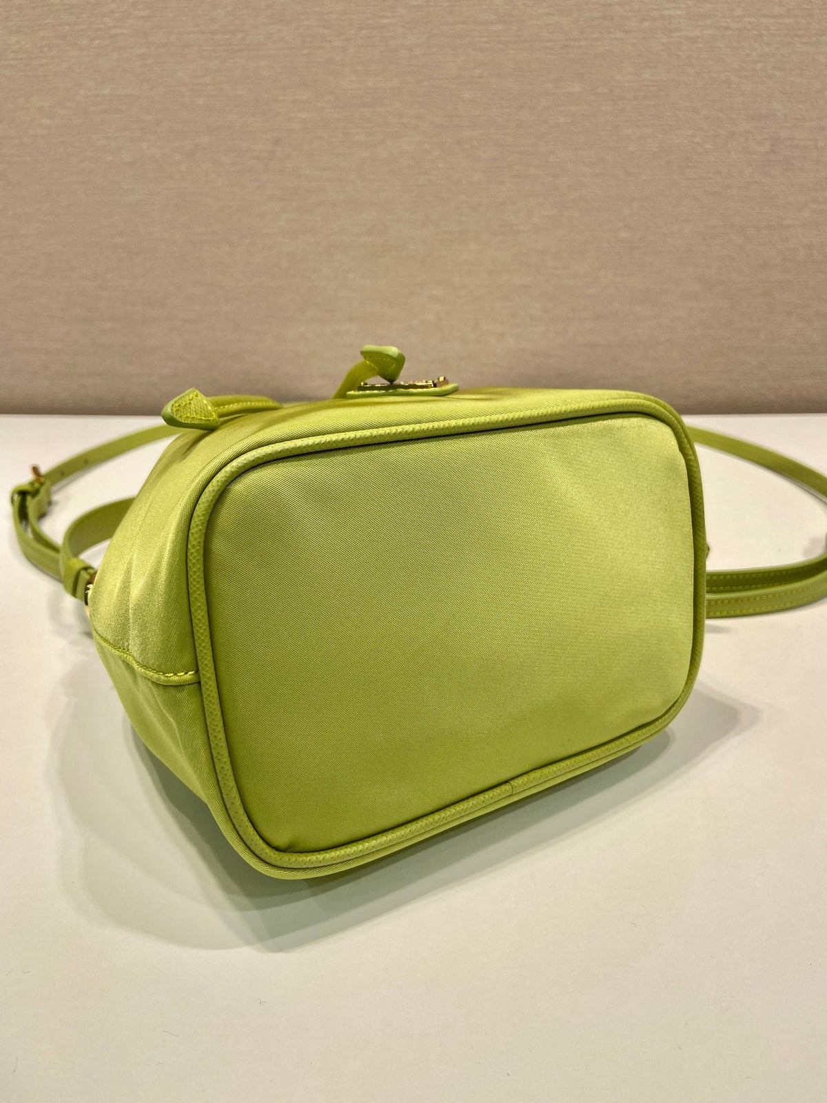 PRADA BUCKET BAG 19 IN APPLE GREEN RE-NYLON AND SAFFIANO LEATHER HANDLE